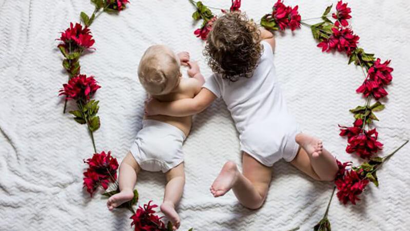 Happy Mother's Day and some tips for coping through the day for those struggling with infertility from Cryos International Sperm and Egg Bank - two babies in a heart made of flowers