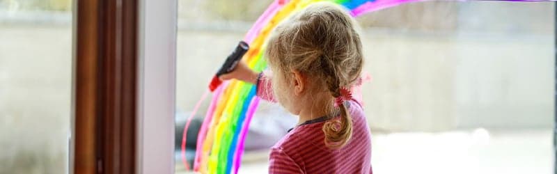 Child of LGBT+ parents painting a rainbow Child of LGBT+ parents painting a rainbow