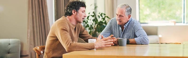 Man talking about fertility treatment with his father Man talking about fertility treatment with his father