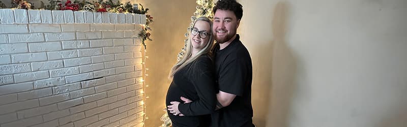 Aaron and Kayla in front of a Christmas tree Aaron and Kayla in front of a Christmas tree