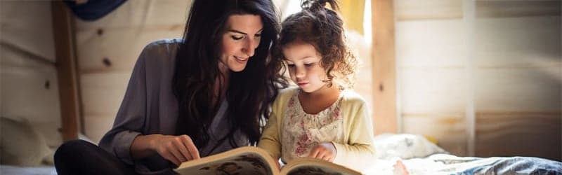 Mother reading a book to her child Mother reading a book to her child