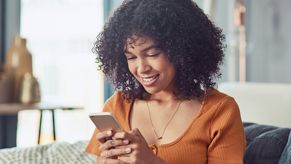 Young donor-conceived woman with phone considering to contact and get in touch with her sperm donor Young donor-conceived woman with phone considering to contact and get in touch with her sperm donor