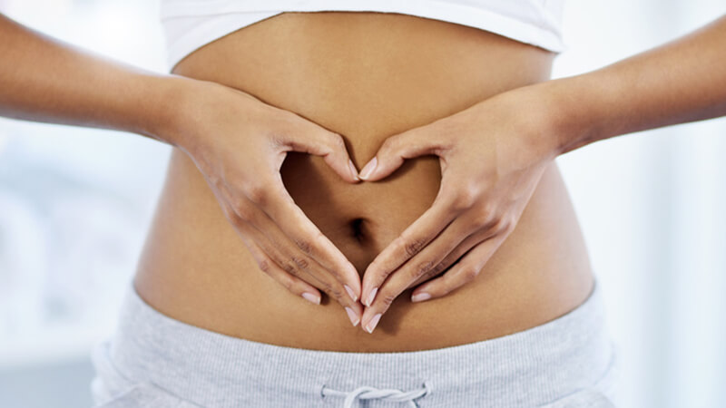 How does ovulation work - woman forming a heart on her stomach