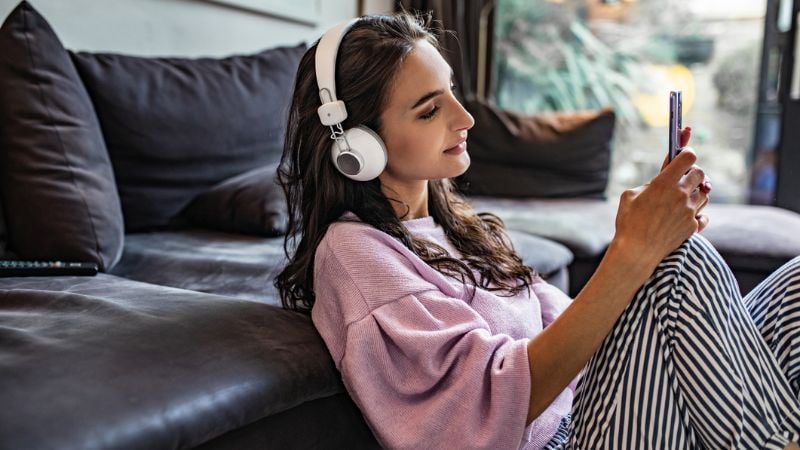 Woman struggling with infertility listening to a podcast