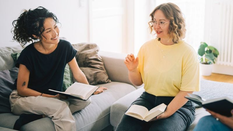 Two women reading a book