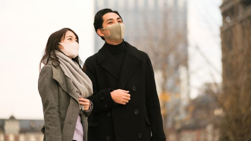 Couple kissing with masks