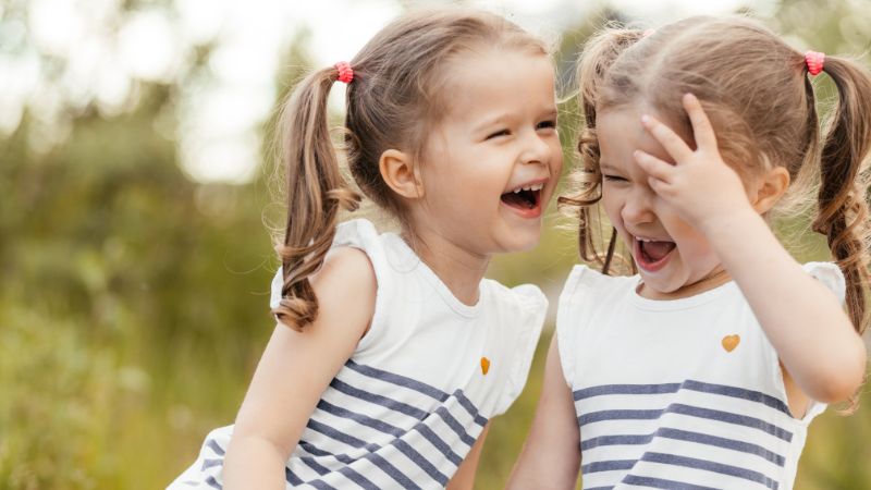 Twins that are donor-conceived laughing
