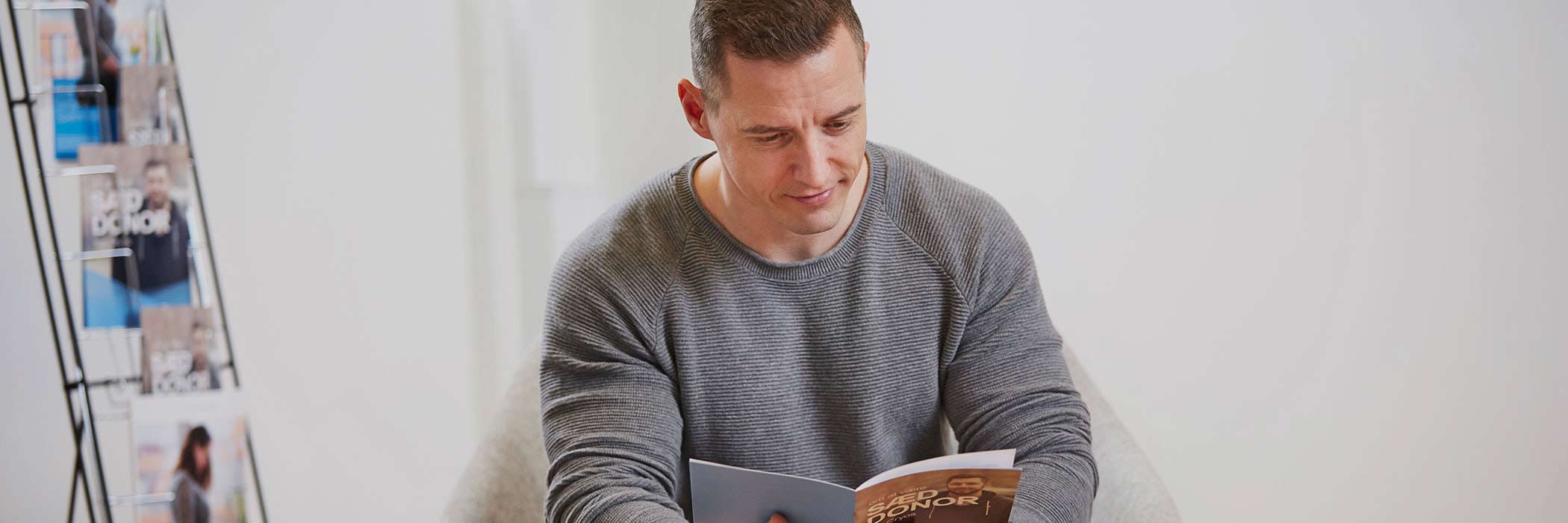 Man reading about how to become a sperm donor at Cryos