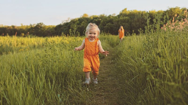 Bambino concepito da donatore che cammina in mezzo a un campo