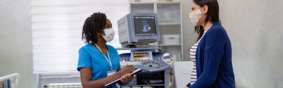 Uma médica de fertilidade a consultar um paciente