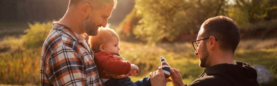 Two dads helping their donor-conceived child