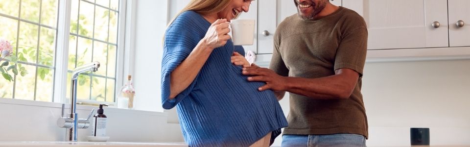 Happy couple in a kitchen with donor eggs