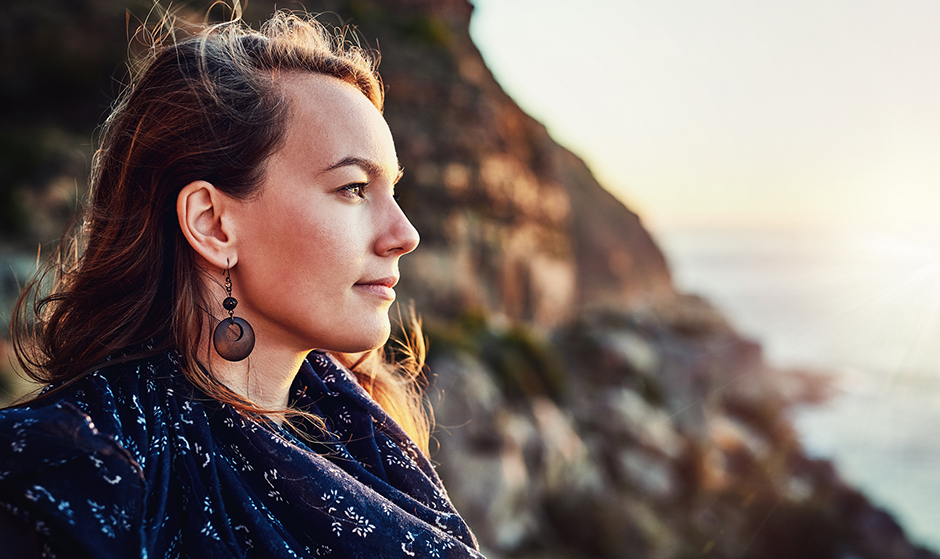 Woman outside considering her reasons for freezing eggs with Cryos 