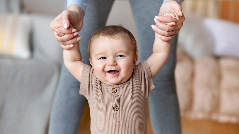 Glückliches Baby macht seine ersten Schritte – lernen Sie die ersten Schritte bei Spendereizellen kennen