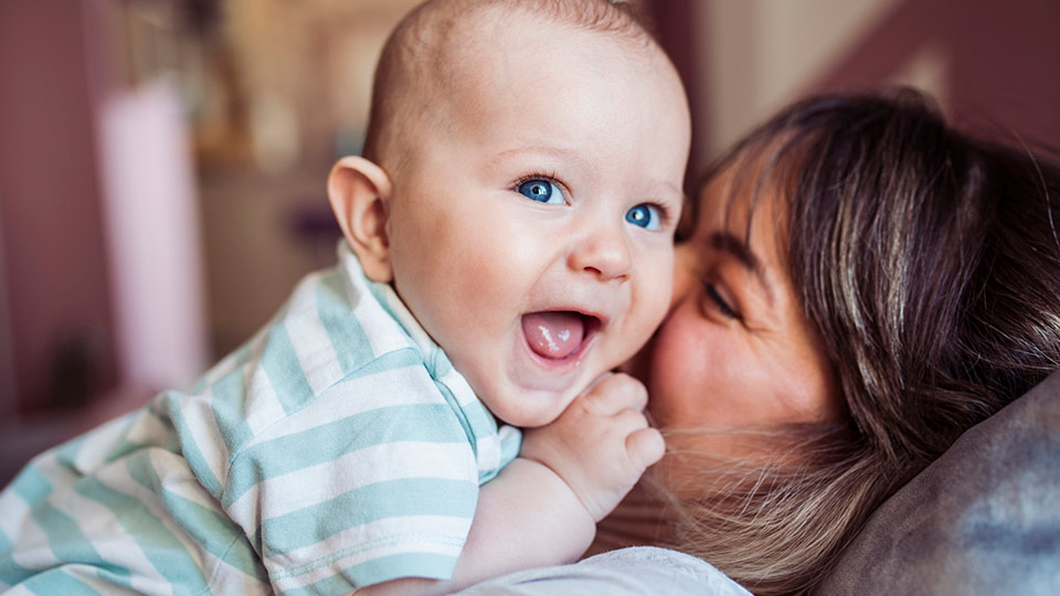 Happy mother with baby after treatment at clinic working with Cryos