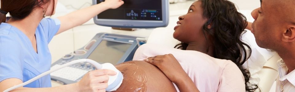 Ultra sound being performed on a happy couple