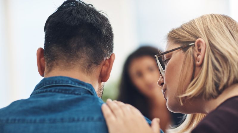Couple in counselling comforting each other 