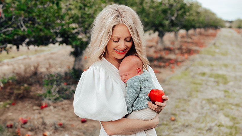 Annmaree holding an apple and her son Annmaree holding an apple and her son