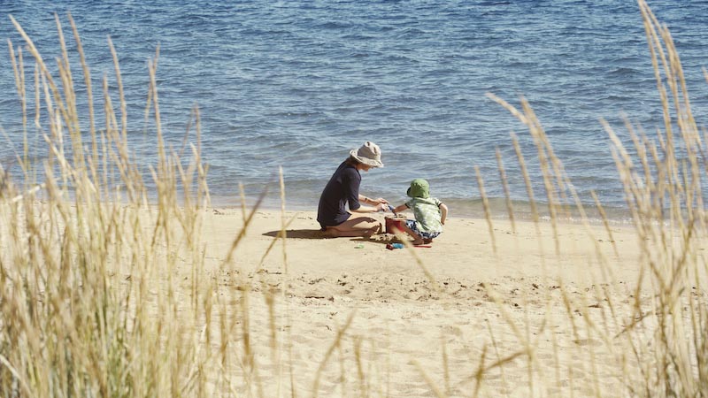 Mum at the beach telling her son about how he came into the world with the help of a donor
