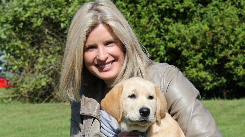 Sarah Stirk sitting with a dog