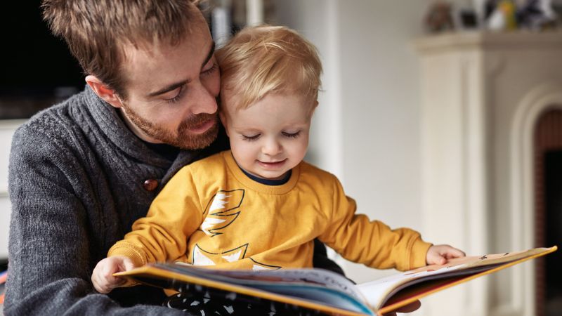 Father and son reading a book