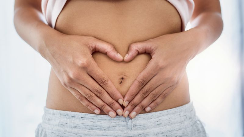 Women holding her hands on her stomach