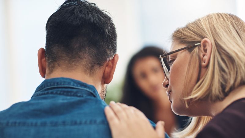 Woman comforting man because of male infertility