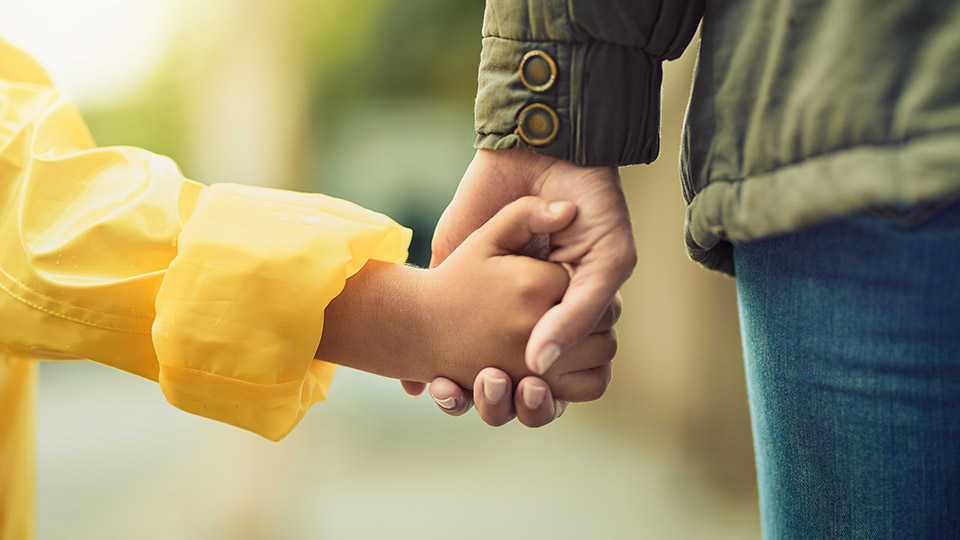 Mother and child holding hands