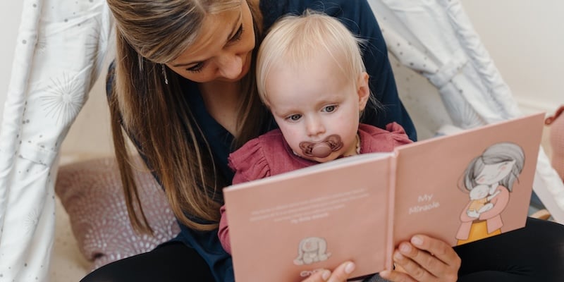 Mother and child reading book about donor conception Mother and child reading book about donor conception
