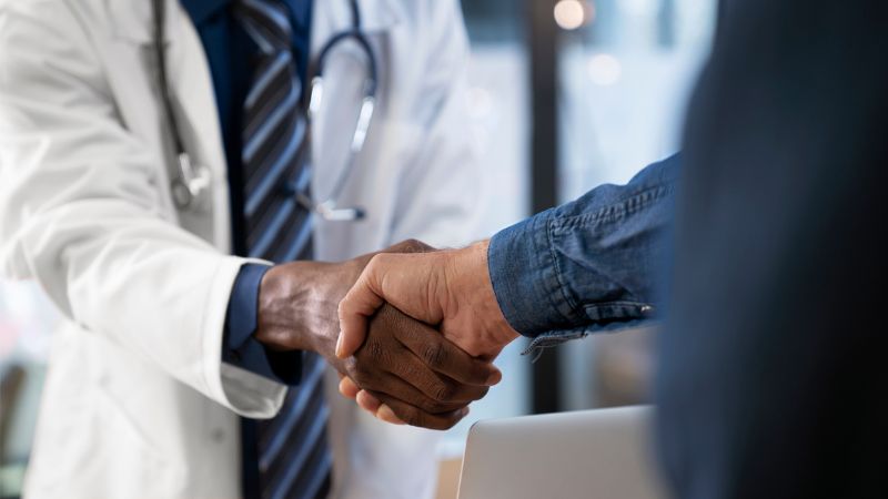 A doctor and a patient shaking hands A doctor and a patient shaking hands