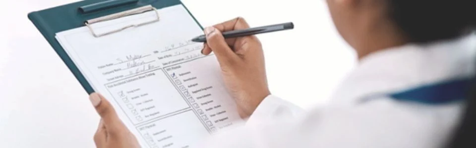 Doctor writing on a paper