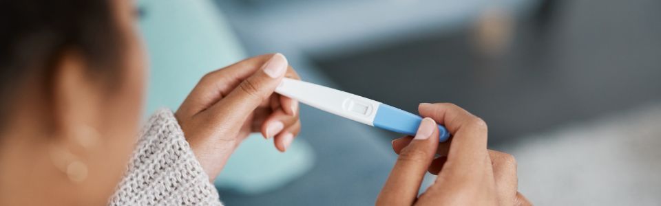 Woman holding a successful pregnancy test