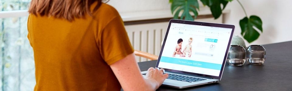 A woman checking the different sperm donor profiles on Cryos