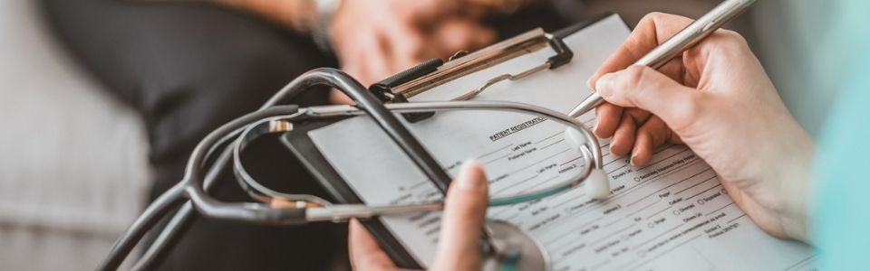Fertility doctor writing on a form
