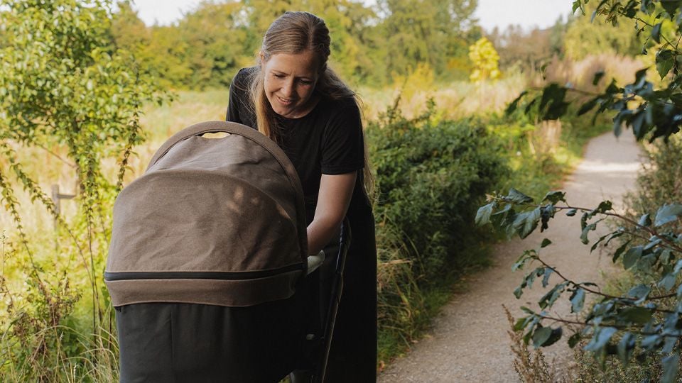 Single mother taking a walk with her baby Single mother taking a walk with her baby