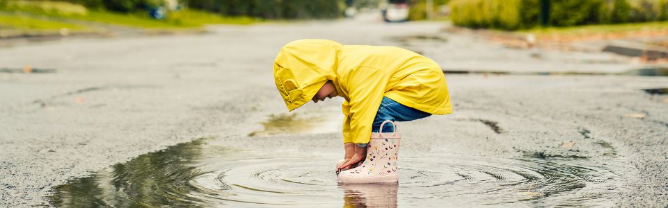 Child playing in a puddle Child playing in a puddle